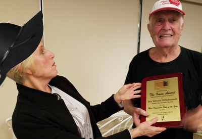 Irwin Zucker, Founder of Book Publicists of Southern California, presents Ina Hillebrandt with the coveted IRWIN AWARD, for Most Provocative Book of the Year 